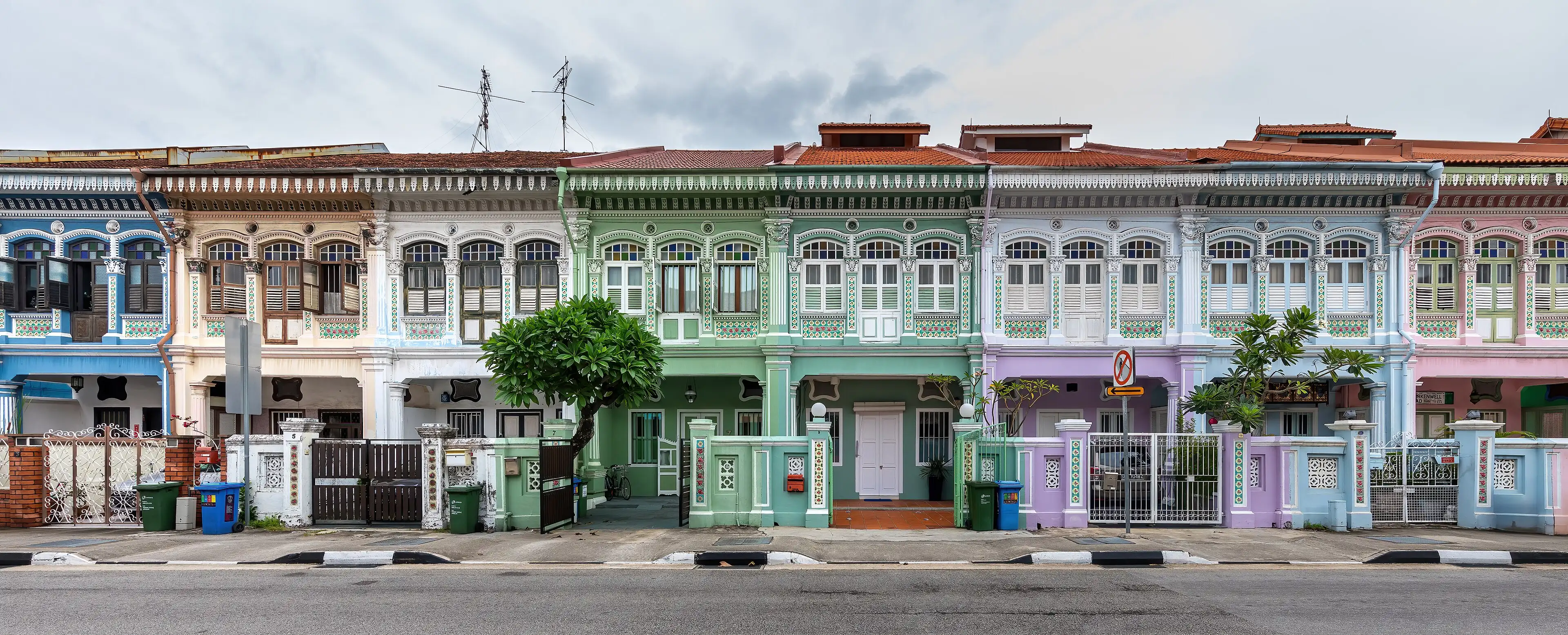 A row of pastel-coloured shophouses on Koon Seng Road.